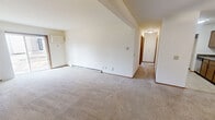 This 830 square foot apartment in Madison, WI offers a compact yet functional living space. The galley-style kitchen is equipped with wooden cabinets, granite-like countertops, and modern appliances including a refrigerator and stove. The living area features carpeting and a sliding glass door that provides natural light and access to an outdoor space.

The bathroom is outfitted with a combination tub-shower, white tiled walls, and a vanity with storage. The two bedrooms are carpeted and include closet space, with the primary bedroom measuring 160 square feet. A notable feature is the fireplace in the living area, framed by an elegant wooden mantel and surrounded by ceramic tile.

Throughout the apartment, you'll find neutral wall colors and baseboards that contribute to a clean, modern aesthetic. The layout maximizes the available space, with each room flowing logically into the next. Window treatments and ceiling fans are included for comfort and privacy. This single-story unit combines practicality with comfort, making it suitable for individuals or small families seeking an efficient living space in a convenient Madison location.