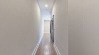 This efficiently designed 530 square foot apartment maximizes space with its thoughtful layout. The single bedroom, measuring 110 square feet, offers a cozy retreat. The unit boasts two bathrooms, providing convenience and privacy. The interior showcases a blend of contemporary and rustic elements, evident in the sleek wood-look flooring that runs throughout the space. A standout feature is the stylish sliding barn door, adding a touch of character while saving space. The main living area is illuminated by recessed lighting and a modern ceiling fan, ensuring both ample light and air circulation. Neutral-toned walls create a bright, airy atmosphere and offer a blank canvas for personalization. The open concept design allows for flexible furniture arrangement, making the space feel larger than its square footage suggests. Despite its compact size, the apartment includes a hallway and a closet, providing essential storage solutions. This well-appointed space is ideal for those seeking a modern, low-maintenance living environment in an urban setting.