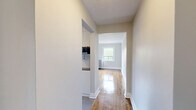 Located at 320 Avenue Rd in Toronto's sought-after Forest Hill neighbourhood, this one-bedroom, one-bathroom unit offers a thoughtfully designed layout across a single floor. The space is finished with warm hardwood flooring throughout the main living areas, complemented by classic white panel doors and crisp white baseboards that lend a clean, timeless aesthetic.

The galley-style kitchen is a standout feature, boasting white cabinetry, a light grey subway tile backsplash, polished grey tile flooring, stainless steel appliances including a stove, dishwasher, and refrigerator, as well as an overhead microwave. A window at the end of the kitchen brings in natural light and views of the surrounding brick architecture.

The bedroom is a comfortable, well-proportioned room featuring gleaming hardwood floors, neutral grey walls, a bright window with views of the neighbouring brick building, and a classic cast-iron radiator — a charming nod to the building's heritage character.

The hallways connect the rooms efficiently, maintaining the flow of the unit. The bathroom is finished with warm beige horizontal tiles surrounding a full soaker tub with a handheld shower fixture, and a frosted window for natural ventilation and light.

Overall, the unit presents a clean, move-in ready space with a blend of classic charm and modern updates.