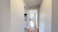 Located at 320 Avenue Rd in Toronto's sought-after Forest Hill neighbourhood, this one-bedroom, one-bathroom unit offers a thoughtfully designed layout across a single floor. The space is finished with warm hardwood flooring throughout the main living areas, complemented by classic white panel doors and crisp white baseboards that lend a clean, timeless aesthetic.

The galley-style kitchen is a standout feature, boasting white cabinetry, a light grey subway tile backsplash, polished grey tile flooring, stainless steel appliances including a stove, dishwasher, and refrigerator, as well as an overhead microwave. A window at the end of the kitchen brings in natural light and views of the surrounding brick architecture.

The bedroom is a comfortable, well-proportioned room featuring gleaming hardwood floors, neutral grey walls, a bright window with views of the neighbouring brick building, and a classic cast-iron radiator — a charming nod to the building's heritage character.

The hallways connect the rooms efficiently, maintaining the flow of the unit. The bathroom is finished with warm beige horizontal tiles surrounding a full soaker tub with a handheld shower fixture, and a frosted window for natural ventilation and light.

Overall, the unit presents a clean, move-in ready space with a blend of classic charm and modern updates.