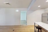 Located at 8365 Dix Ellis Trail in Jacksonville, FL, this well-appointed one-bedroom, one-bathroom unit offers a smart and functional single-floor layout. Light wood-tone flooring flows consistently throughout the space, complementing the crisp white walls and textured ceilings that define its clean aesthetic.

The living room serves as a welcoming focal point, highlighted by a stone-surround fireplace and a small window that brings in natural light. The kitchen is thoughtfully designed with white shaker-style cabinetry featuring frosted glass upper panels, a blue tile backsplash, stainless steel appliances including a refrigerator, range, microwave, and dishwasher, and a marble-top bar table with seating — ideal for casual dining.

The spacious primary bedroom accommodates generous furnishings and is filled with natural light from a large window with blinds. It offers direct access to the bathroom and a dedicated closet with built-in hanging storage. A second closet provides additional storage throughout the unit.

The bathroom includes a full tub-shower combo with white tile surround and light tile flooring. A separate utility room houses an in-unit washer, adding everyday convenience. Recessed lighting throughout enhances the bright, modern feel of the entire unit.