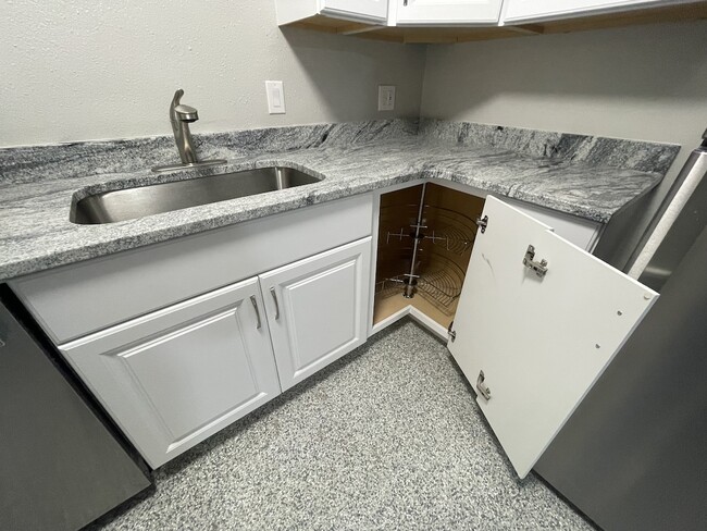 Corner cabinet features lazy Susan for easy access - 516 Shady Pl