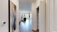 Located at 2200 Progress Pkwy in Schaumburg, IL, this well-appointed studio offers a smart, efficient single-floor layout that maximizes every inch of its living space. The open-concept design seamlessly connects the kitchen and living area, creating a cohesive and functional environment.

The kitchen is a standout feature, outfitted with rich, dark cabinetry, stainless steel appliances including a gas range, microwave, and dishwasher, and crisp white quartz countertops complemented by a classic subway tile backsplash. A kitchen island provides additional prep space and casual seating, making it ideal for both cooking and entertaining.

The living area is bright and airy, benefiting from large, black-framed floor-to-ceiling windows and a sliding glass door that floods the space with natural light and offers views of the surrounding outdoor greenery. Light hardwood-style flooring runs throughout, enhancing the open and modern feel of the unit.

A well-organized entryway features a built-in closet with ample shelving, providing practical storage. The bathroom includes a glass-enclosed shower with clean white tile, offering a sleek and contemporary finish.

The overall ambiance is modern and inviting, with crisp white walls, clean architectural lines, and thoughtful design details throughout that make this a comfortable and stylish living space.