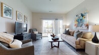 Located at 277 Bend Blvd in Westerville, Ohio, this well-appointed single-floor residence offers a thoughtfully designed layout with modern finishes and a bright, welcoming ambiance. The open-concept living area is anchored by light wood-look flooring and large sliding glass doors that lead to a private balcony, filling the space with natural light and offering pleasant outdoor views. The kitchen is a standout feature, showcasing white cabinetry, granite countertops, stainless steel appliances, and a generously sized island with bar seating and pendant lighting — ideal for both everyday living and entertaining. The primary bedroom is a comfortable retreat, carpeted for warmth, with a large window that brings in ample natural light. It connects to a well-appointed en-suite bathroom featuring a dual-sink vanity with granite countertops, white cabinetry, a glass-enclosed shower, and an adjoining walk-in closet. A second bedroom, also carpeted and naturally lit, provides versatile space for guests or a home office. A walk-in closet adjacent to one of the bathrooms adds to the generous storage throughout. The overall aesthetic is clean and contemporary, with neutral tones creating a cohesive and inviting atmosphere.