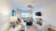 This well-appointed three-bedroom, three-bathroom home in Oxford, Mississippi, offers a thoughtfully designed single-floor layout that balances comfort and functionality. Rich hardwood-style flooring flows throughout the space, anchoring each room with warmth and continuity.

The inviting living room features a ceiling fan, large windows that allow natural light to fill the space, and ample room for relaxed seating arrangements. A wall-mounted TV and tasteful décor give the area a welcoming ambiance. Adjacent, the combined kitchen and dining area is outfitted with warm-toned cabinetry, stainless steel appliances including a refrigerator, range, and microwave, plus a central island with a clean white countertop ideal for casual dining. A pantry provides additional storage convenience.

The primary bedroom is generously sized, offering a ceiling fan, large windows with blinds, and a dedicated closet. The two additional bedrooms are equally comfortable, each with ceiling fans, natural light, and their own closets. All three bathrooms are well-equipped; one features a tub/shower combo and vanity with rich wood cabinetry. A dedicated laundry room and utility space round out the practical amenities of this home, making it a complete and functional residence in the heart of Oxford.