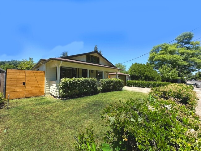 Street-side view showcasing the spacious front yard and inviting main elevation. - 4570 58th St