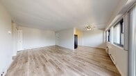 Located at 2751 N 47th St in Philadelphia, PA, this two-bedroom, two-bathroom unit offers a well-organized single-floor layout designed for comfortable living. The open living area is a highlight of the space, featuring light-toned hardwood flooring throughout and large sliding glass doors that lead to a private balcony, flooding the room with natural light and offering pleasant outdoor views of surrounding greenery. A ceiling fan adds functionality to the living space, which flows seamlessly through connecting hallways.

The kitchen is efficiently designed with white cabinetry, dark countertops, and black appliances including a refrigerator, dishwasher, and oven, all set atop matching hardwood floors. The layout makes practical use of every corner of the space.

The spacious primary bedroom features a large window with tree-lined views, a wall-mounted A/C unit, track lighting, and hardwood flooring. The second bedroom includes a built-in closet with sliding doors, providing ample storage. Both bedrooms offer a calm, neutral aesthetic.

The two bathrooms are clean and functional — one equipped with a walk-in shower and the other with a full bathtub, both featuring tile flooring and dark-framed medicine cabinets. Three hallways connect the rooms, ensuring a logical and accessible flow throughout this well-appointed Philadelphia residence.