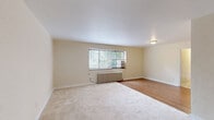 Located in Pittsburgh's desirable Shadyside neighborhood, this 2-bedroom, 1-bathroom unit at 5530 5th Ave offers a practical and comfortable layout across a single floor. The living room is generously proportioned, featuring a combination of hardwood flooring and plush carpet, with a large window that fills the space with natural light and views of surrounding greenery. A classic cast-iron radiator provides character and warmth. The kitchen is efficiently designed with warm wood cabinetry, stainless steel countertops, a gas range, dishwasher, and a window that brings in additional natural light. The primary bedroom is a well-sized retreat with carpet flooring, a window overlooking the outdoors, and a radiator, complemented by two interior doors — one leading to a closet and another to the hallway. The second bedroom is a cozy, carpeted room with its own window and radiator. The full bathroom showcases classic retro charm with pink ceramic tile walls accented by a navy blue tile border, a white soaking tub, hexagonal mosaic floor tiles, a pedestal-style vanity, and a window. A connecting hallway ties the rooms together, completing this well-organized and characterful unit.
