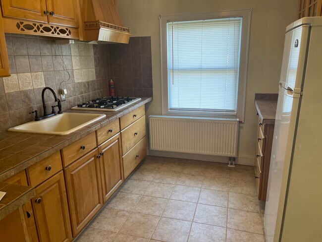 Kitchen - Includes gas range and new stainless steel refrigerator (not pictured). - 1128 Caldwell Ave