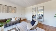 This two-bedroom, one-bathroom residence in Nottingham, MD offers a well-organized single-level layout designed for comfortable everyday living. The living room serves as the heart of the home, featuring warm wood-style flooring, bright white walls, and a large sliding glass door that opens onto a private balcony with open views of the surrounding greenery — filling the space with abundant natural light. The kitchen is outfitted with white cabinetry with black hardware, a white quartz countertop, stainless steel appliances including a refrigerator, dishwasher, electric range, and microwave, plus wood-style flooring and a window for added brightness. The primary bedroom is a comfortable retreat with plush carpet, a generous closet, and a window that invites natural light. The second bedroom also features soft carpeting, a closet, and clean white walls. The full bathroom is finished with wood-style flooring, white cabinetry, and a tub-shower combination. A hallway connects the rooms efficiently, contributing to a logical and functional flow throughout the home. The overall aesthetic is clean and modern, with a neutral palette that offers a versatile canvas throughout.
