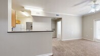 This well-appointed one-bedroom, one-bathroom residence in Victoria, TX offers a thoughtfully designed single-floor layout that maximizes comfort and functionality. The open-concept living area features warm neutral tones, plush carpeting, and crown molding, with a ceiling fan providing year-round comfort. A door with sidelights invites natural light into the living space, creating a bright and welcoming atmosphere.

The kitchen is efficiently designed with warm oak cabinetry, dark countertops, wood-style flooring, and white appliances including a range, over-the-range microwave, and refrigerator. A peninsula breakfast bar connects the kitchen to the living area, making it ideal for casual dining or entertaining.

The bedroom is a comfortable retreat, carpeted and finished with neutral walls, a ceiling fan with light, and a window with blinds that allows natural light while maintaining privacy. A dedicated closet provides ample storage.

The full bathroom is well-equipped with an oak vanity, dark countertop, tiled tub-shower combo, and easy-care tile flooring. Adding to the unit's practicality is a dedicated laundry room with wire shelving and full-size washer and dryer hookups, complemented by wood-style flooring for easy maintenance.