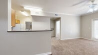 This well-appointed one-bedroom, one-bathroom residence in Victoria, TX offers a thoughtfully designed single-floor layout that maximizes comfort and functionality. The open-concept living area features warm neutral tones, plush carpeting, and crown molding, with a ceiling fan providing year-round comfort. A door with sidelights invites natural light into the living space, creating a bright and welcoming atmosphere.

The kitchen is efficiently designed with warm oak cabinetry, dark countertops, wood-style flooring, and white appliances including a range, over-the-range microwave, and refrigerator. A peninsula breakfast bar connects the kitchen to the living area, making it ideal for casual dining or entertaining.

The bedroom is a comfortable retreat, carpeted and finished with neutral walls, a ceiling fan with light, and a window with blinds that allows natural light while maintaining privacy. A dedicated closet provides ample storage.

The full bathroom is well-equipped with an oak vanity, dark countertop, tiled tub-shower combo, and easy-care tile flooring. Adding to the unit's practicality is a dedicated laundry room with wire shelving and full-size washer and dryer hookups, complemented by wood-style flooring for easy maintenance.