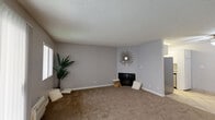 Located at 16818 Downey Ave in Paramount, CA, this single-story, 2-bedroom, 1-bathroom unit offers a practical and comfortable layout across its compact footprint. The living room is an open, carpeted space bathed in natural light through large sliding glass doors and a window fitted with vertical blinds, providing outdoor views and easy access to the exterior. A wall-mounted air conditioning unit keeps the space comfortable year-round. The kitchen is efficiently designed with white cabinetry, a stainless steel dishwasher, a full-size refrigerator, and tile flooring underfoot. A ceiling fan with a light fixture adds both function and airflow to the kitchen area. The hallway connects the main living spaces to the bedrooms and features light tile flooring and built-in overhead storage cabinetry. Both bedrooms are carpeted and finished with neutral gray walls and textured ceilings. The primary bedroom is notably spacious, with a window allowing natural light, a wall AC unit, and a closet. The second bedroom also features vertical blinds and ample natural light. The bathroom is clean and functional, with a white vanity, dual mirrored medicine cabinets, a lighted vanity bar, and tile flooring throughout.