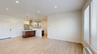 Located in Keizer, Oregon, this thoughtfully designed two-bedroom, two-bathroom residence offers a clean, modern aesthetic across a single level. The open-concept kitchen and living area serves as the heart of the home, showcasing light wood-tone flooring, recessed lighting, and a striking oversized kitchen island topped with dramatic veined quartz countertops. White shaker-style cabinetry with matte black hardware lines the kitchen walls, complemented by a subway tile backsplash, stainless steel appliances including a gas range with a stainless hood, refrigerator, and dishwasher, along with stylish pendant lighting overhead. The living area benefits from a wide bank of windows that invite natural light and offer pleasant outdoor views of the surrounding neighborhood. Both bedrooms are carpeted and finished in neutral tones, providing a calm retreat. The primary bedroom features generous double closets with sliding panel doors. The bathrooms are well-appointed — one includes a walk-in shower with wood-look flooring and a white vanity with veined quartz, while the second showcases a soaking tub and shower combination enclosed in striking marble-look tile with matte black fixtures. Throughout the residence, clean lines, neutral palettes, and quality finishes create a cohesive and inviting atmosphere.