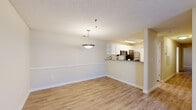 Located at 616 Issaqueena Trail in Clemson, SC, this three-bedroom, two-bathroom single-floor home offers a well-organized layout with consistent finishes throughout. The open-concept living and dining area features light wood-style flooring, neutral beige walls with chair rail molding, and a textured ceiling. A pendant light fixture anchors the dining space, which flows seamlessly into the kitchen. The kitchen is equipped with white cabinetry, stainless steel appliances including a refrigerator and microwave, and a granite-topped breakfast bar that opens to the dining and living areas. The living room includes a ceiling fan, access to a private outdoor area via a glass-panel door, and windows that bring in natural light. Each of the three bedrooms features light wood-style flooring, ceiling fans with light fixtures, and closets. The bedrooms maintain a neutral color palette, providing a clean and adaptable space. Both bathrooms are finished with wood-look tile flooring, white vanities with granite countertops, and full tub-shower combinations with white surrounds. Three dedicated closets provide ample storage throughout the home. The overall ambiance is clean, functional, and move-in ready.