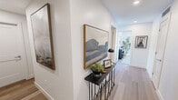 This contemporary 880 square foot condo in London, Ontario offers a harmonious blend of style and functionality. The open-concept layout seamlessly integrates the kitchen, living, and dining areas, creating a spacious feel. The kitchen boasts sleek cabinetry, stainless steel appliances, and a generous island with seating.

Floor-to-ceiling windows flood the space with natural light and provide stunning city views. The living room features a comfortable seating area and a modern entertainment unit. Both bedrooms are well-appointed, with the primary bedroom measuring 120 square feet. The bathrooms showcase luxurious finishes, including marble-like tiling and glass shower enclosures.

Throughout the condo, neutral tones and warm wood flooring create a cohesive, inviting atmosphere. Thoughtful details such as recessed lighting, stylish fixtures, and carefully curated artwork enhance the overall aesthetic. The unit's clever design maximizes storage with built-in closets and cabinets.

This condo, located at 2016 Linkway Blvd in London, offers a perfect balance of urban living and comfort, ideal for those seeking a modern, low-maintenance lifestyle in the heart of the city.