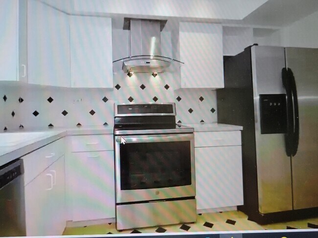 kitchen with stainless appliances - 215 NE 16th Ave