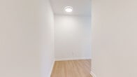 This single-floor unit at 3836 Bank St in Baltimore's 21224 zip code presents a thoughtfully designed layout with a consistently modern aesthetic. Light wood-tone flooring runs throughout the space, complementing crisp white walls and clean-lined trim to create a bright, cohesive environment.

The living area benefits from multiple windows that invite natural light and offer views of the surrounding neighborhood streetscape. The kitchen is well-appointed with white flat-front cabinetry extending to the ceiling, stone-look countertops, stainless steel appliances including a range and over-the-range microwave, a stainless undermount sink, and a soft blue ceramic tile backsplash that adds a subtle accent of color.

The bedrooms are generously proportioned, each featuring light-filled windows with neighborhood views and the same warm wood-tone flooring. Additional rooms offer flexible use with flush-mount ceiling lighting and clean finishes.

Two full bathrooms echo the unit's modern sensibility, each featuring a soaking tub with white subway tile surrounds, an undermount sink set into a white vanity, a large mirror, and distinctive hexagonal tile flooring. One bathroom features elegant pendant lighting for an elevated touch. The overall ambiance is clean, contemporary, and move-in ready.