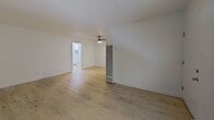 Located at 5330 Corteen Place, Unit 6 in Valley Village, Los Angeles, this efficiently designed 1-bedroom, 1-bathroom apartment offers 560 square feet of thoughtfully laid-out single-floor living space. Throughout the unit, light wood-style flooring creates a clean, modern aesthetic that ties every room together seamlessly.

The combined kitchen and living area forms the heart of the home. The kitchen is equipped with white cabinetry, granite-style countertops, a stainless steel sink, and a full-size refrigerator, while a ceiling fan overhead provides comfortable airflow into the adjoining living space. Natural light filters in through a window, keeping the area bright and welcoming.

The living room is open and airy, featuring white walls, a textured ceiling, and a wall-mounted heater unit. The space flows naturally toward the 140-square-foot bedroom, which includes a window with blinds that allows for ample natural light.

The bathroom stands out as a notable highlight, showcasing floor-to-ceiling marble-style tile surrounding a soaking tub and shower combination with matte black fixtures. A white vanity with an integrated sink and a framed mirror complete the polished look. The unit's clean, neutral palette throughout provides a versatile canvas ready for personalization.