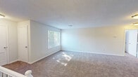Located at 401 Talcottville Rd in Vernon Rockville, Connecticut, this one-bedroom, one-bathroom residence offers a practical and comfortable layout across a single floor. The living room is generously sized, featuring plush wall-to-wall carpeting, crisp white walls, a textured ceiling, and multiple windows fitted with blinds that allow natural light to fill the space with a bright, airy feel. The well-designed kitchen is a standout feature, showcasing white shaker-style cabinetry, dark granite countertops, a stainless steel sink, and stainless steel appliances including a gas range and over-the-range microwave. A window above the counter brings in natural light, enhancing the clean, functional workspace. The bedroom is a comfortable retreat, also carpeted, and benefits from two windows that frame views of surrounding greenery. A double closet provides convenient storage, with direct access to the full bathroom. The bathroom is finished with a granite-topped white vanity, tiled flooring, a shower/tub combination, and a window that adds ventilation and light. Additional features include two closets, a utility room, and staircase access. The overall aesthetic is clean and neutral, providing a move-in ready environment.