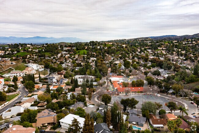 aerial of neighborhood with mountains and school