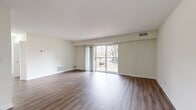 This 790 square foot apartment in the Commons At Windsor Gardens offers a blend of comfort and functionality. The space consists of three bedrooms, including a primary bedroom of 170 square feet, one bathroom, and an open-concept kitchen and living area. Throughout the apartment, warm wood-tone flooring creates a cohesive and inviting atmosphere.

The kitchen showcases contemporary blue-gray cabinetry, contrasting beautifully with stainless steel appliances and white countertops. A subway tile backsplash adds a touch of classic elegance. The living area is spacious and filled with natural light from large windows, some offering views of the surrounding greenery.

Bedrooms are generously sized, with ample closet space featuring wire shelving systems. The bathroom is pristine, with a white vanity, toilet, and a shower/tub combination. In-unit laundry facilities add convenience to daily living.

A standout feature is the balcony, accessible through sliding glass doors, providing an outdoor extension of the living space. The apartment's layout maximizes space efficiency, making it ideal for comfortable living and entertaining. Located in Norwood, MA, this property combines modern amenities with a serene suburban setting.