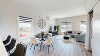 Located at 400 Grey Heron Drive in Winnipeg, this thoughtfully designed two-storey home offers three bedrooms and three bathrooms across two floors of contemporary living space. The main floor features an open-concept kitchen, dining, and living area bathed in natural light from multiple windows with stylish roller blinds. The kitchen is equipped with stainless steel appliances, warm wood cabinetry, a large white quartz waterfall island with bar seating, and sleek pendant lighting. The adjacent living and dining areas flow seamlessly together, highlighted by light wood-look flooring and a wall-mounted mini-split system. A convenient in-unit stacked washer and dryer is tucked neatly into a dedicated closet on this level. The upper floor houses three bedrooms, including a primary bedroom with its own ensuite bathroom featuring a tub-shower combination. Additional bedrooms are well-proportioned, with one featuring built-in shelving, offering practical storage. The three bathrooms throughout maintain a consistent modern aesthetic with wood-toned vanities and clean white finishes. Light, neutral tones and warm wood accents throughout create a cohesive, welcoming ambiance across the entire home.