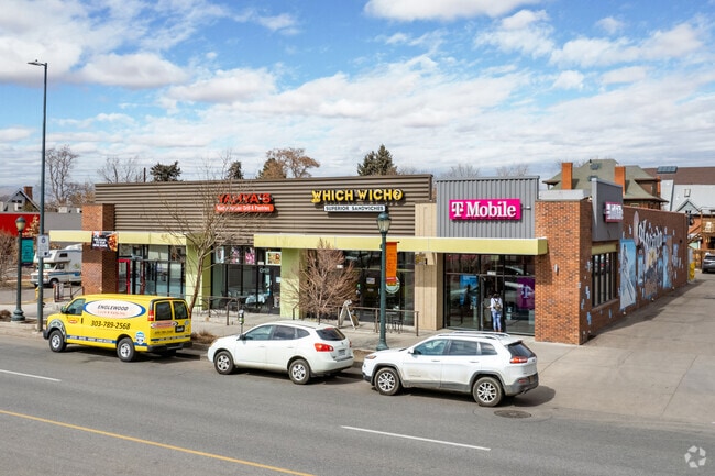 Storefronts line Colfax near Cheesman Park in Denver.