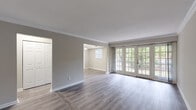 Located in Brookhaven, Georgia, this single-story residence offers a well-appointed layout designed for comfortable living. The spacious living area is a standout feature, highlighted by beautiful hardwood-style flooring, crown molding, and a wall of French doors that flood the room with natural light and provide direct access to an outdoor area surrounded by lush greenery. The living space flows openly into an adjacent dining or secondary living area, creating a connected and airy feel throughout.

The kitchen is thoughtfully updated with white shaker-style cabinetry, granite countertops, a subway tile backsplash, stainless steel appliances including a range, microwave, and dishwasher, and a double sink beneath a window. Light tile flooring completes the clean, functional aesthetic.

The bedrooms feature plush carpeting, crown molding, and ample closet space. Multiple windows allow natural light to filter in, enhancing each room's welcoming atmosphere. The bathroom is finished with white cabinetry, granite countertops, a large vanity mirror, and tile flooring, maintaining a cohesive and polished look throughout.

A dedicated in-unit laundry area accommodates a full-size washer and dryer, adding everyday convenience. Overall, this residence combines classic architectural details with modern updates in a serene Brookhaven setting.