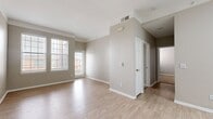 This contemporary 830 square foot apartment in Aurora, Colorado offers a harmonious blend of style and functionality. The space features two bedrooms and two bathrooms, with the primary bedroom boasting a generous 140 square feet. The heart of the home is a sleek, updated kitchen, showcasing crisp white cabinetry, stainless steel appliances, and a stylish hexagonal tile backsplash. A central island provides additional counter space and casual dining options.

The living areas are characterized by a neutral color palette, creating a bright and airy atmosphere. Large windows in the bedrooms and living room flood the space with natural light, while offering views of the surrounding area. The flooring alternates between plush carpeting in the bedrooms and wood-look laminate in the main living areas, adding both comfort and easy maintenance.

Both bathrooms feature modern fixtures, with at least one including a full-size bathtub. The apartment's layout is efficient, with a hallway connecting the various rooms and providing access to a closet for additional storage. Crown molding throughout adds a touch of elegance to the overall design. This well-appointed apartment offers a perfect balance of comfort and contemporary urban living.