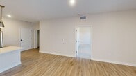 This well-designed 1010 square foot apartment in Cedar Rapids, Iowa, offers a harmonious blend of modern amenities and practical living spaces. The open-concept floor plan seamlessly integrates the kitchen, living, and dining areas, creating a spacious and inviting atmosphere. The kitchen is a standout feature, boasting ample cabinetry, stainless steel appliances, and a large central island with a sink, perfect for food preparation and casual dining.

The bedroom, measuring 290 square feet, is generously sized and carpeted for comfort. It features a ceiling fan and a large window, allowing natural light to flood the space. The bathroom is sleek and contemporary, with a single vanity and a combination shower/tub.

Throughout the apartment, you'll find a mix of flooring types, including wood-look laminate in the main living areas and carpet in the bedroom, adding warmth and texture to the space. The in-unit laundry room is equipped with full-sized, stacked washer and dryer units, offering convenience and efficiency.

Lighting is well-considered throughout, with a combination of recessed lighting and stylish pendant fixtures in the kitchen. Large windows in the living areas and bedroom provide ample natural light and views of the surroundings. The apartment's neutral color palette creates a bright, airy feel and allows for personalization of the space.

This modern apartment combines functionality with contemporary design, making it an ideal home for those seeking a comfortable and stylish living environment in Cedar Rapids.