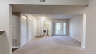 Located in McDonough, Georgia, this two-bedroom, one-bathroom residence offers a practical and comfortable single-floor layout. The living area features a mix of hardwood-style flooring near the entry and soft carpeting throughout, complemented by textured ceilings and neutral wall tones that create a clean, versatile backdrop. A closet near the entryway adds convenient storage from the moment you walk in.

The kitchen is well-appointed with warm wood cabinetry, granite-style countertops, dark hardwood-style flooring, and black appliances including a refrigerator, range, and dishwasher. An adjacent pantry provides additional storage to keep the space organized.

Both bedrooms are carpeted and filled with natural light from large windows with exterior views. The primary bedroom is generously sized and features dual closets, offering ample storage. The second bedroom is equally bright and comfortable.

The full bathroom includes a clean, white tiled tub-shower combination. A dedicated laundry area houses a washer and water heater, adding everyday convenience. The thoughtful layout maximizes every inch of this efficiently designed home, making it a practical and inviting living space.