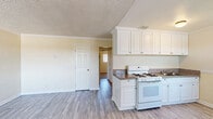 Located at 2509 Edison Ave in Sacramento, California, this single-story 2-bedroom, 1-bathroom home offers a practical and comfortable layout. The space is thoughtfully organized, with all rooms accessible via a central hallway that connects the living areas seamlessly.

The kitchen is well-appointed with white cabinetry, a gas range, a full-size refrigerator, and a sink with dark countertops. Light wood-style flooring runs throughout the kitchen and common areas, and a ceiling fan with integrated lighting adds comfort and warmth to the space. Crown molding provides a clean, finished look.

Both bedrooms feature soft carpeting, ceiling fans, and windows fitted with vertical blinds that allow for natural light and privacy. The primary bedroom includes a large sliding-door closet, offering ample storage. Crown molding and a textured ceiling add subtle architectural character to the bedrooms.

The bathroom is neatly designed with wood-style flooring, a white vanity with a medicine cabinet mirror, a lighted vanity bar, and a tiled shower area. Clean white fixtures and neutral walls give the bathroom a fresh, functional aesthetic.

Overall, the home presents a clean, neutral palette with warm beige tones throughout, creating a welcoming and move-in-ready atmosphere suited for comfortable everyday living.