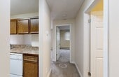 Located at 2000 Saddleback Road NW, this one-bedroom, one-bathroom unit offers a practical and comfortable single-floor layout. The living room is a generously sized, light-filled space featuring soft carpeting, neutral beige walls, baseboard heating, and a sliding glass door that opens to a balcony with outdoor views — an ideal spot for relaxing or letting in natural light.

The kitchen is positioned adjacent to the main living area and features warm wood-toned cabinetry, granite-style laminate countertops, and a white dishwasher, offering a functional cooking and prep space. A short hallway connects the main areas to the bedroom and bathroom.

The primary bedroom is a well-proportioned retreat with plush carpeting, a bright window fitted with blinds, baseboard heating, and a mirrored sliding closet that enhances the sense of space. The textured ceiling adds a classic touch consistent throughout the unit.

The bathroom is finished with wood-look tile flooring, a warm wood vanity with a granite-style countertop and an integrated sink, a well-lit mirror with overhead lighting, and a tub-shower combination with white tile surround.

Overall, the unit presents a clean, functional, and cohesive design with neutral tones throughout, providing a comfortable and move-in ready living environment.