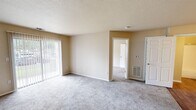 Located at 400 Northport Dr in Cabot, Arkansas, this single-story, one-bedroom, one-bathroom unit offers a practical and well-organized layout. The galley-style kitchen is a functional highlight, featuring white cabinetry, marble-look countertops, a stainless steel sink, and black appliances including a refrigerator, electric range, and dishwasher. Warm wood-look flooring runs through the kitchen and bathroom, adding a cohesive, clean aesthetic to the space.

The carpeted bedroom is comfortably sized, filled with natural light from a window fitted with blinds, and includes access to a dedicated walk-in closet complete with wire shelving for organized storage. A second door from the bedroom leads conveniently to the bathroom.

The bathroom features wood-look flooring, a full tub-shower combination, a toilet, vanity with storage cabinetry above, and additional overhead shelving for linens or toiletries.

A separate closet space serves as a utility area, housing the water heater alongside wire shelving, offering practical storage solutions. Textured ceilings and neutral beige walls throughout the unit create a clean, move-in-ready atmosphere suited for comfortable single-occupant or couple living.