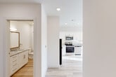 Located at 224 W 25th St in Chattanooga's vibrant Southside neighborhood, this thoughtfully designed one-bedroom, one-bathroom unit offers a clean, modern aesthetic from entry to exit. Light wood-style flooring runs seamlessly throughout, complementing the crisp white walls and recessed lighting that keep every room bright and welcoming.

The open kitchen is a standout feature, outfitted with white shaker cabinetry, granite countertops, a full suite of stainless steel appliances — including a refrigerator, range, microwave, and dishwasher — and a sink positioned beneath a window for natural light while cooking. The kitchen flows directly into the living area, which benefits from large windows and a glass door that flood the space with sunlight and provide outdoor access.

The bedroom is a comfortable, well-proportioned retreat featuring a ceiling fan, a large window with blinds, and direct access to a dedicated walk-in closet complete with wire shelving for organized storage.

The bathroom is finished with white cabinetry, granite countertops, a framed mirror, and a full bathtub-shower combination — all continuing the unit's cohesive, contemporary design language. A connecting hallway efficiently links all rooms, maximizing the functional layout of this well-appointed Chattanooga residence.