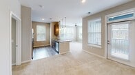 Located at 14210 Liberty Enclave Dr in Huntersville, NC, this well-appointed three-bedroom, two-bathroom single-story home offers a thoughtfully designed open-concept layout. The kitchen serves as the heart of the home, showcasing granite countertops, a peninsula with an undermount sink, pendant lighting, subway tile backsplash, stainless steel appliances including a French door refrigerator, and dark cabinetry. The kitchen flows seamlessly into the dining and living areas, which are bathed in natural light from multiple windows fitted with blinds. A ceiling fan adds comfort to the living space, while wood-look flooring grounds the kitchen and wet areas. The three bedrooms are carpeted and offer a calm, neutral palette, with windows providing outdoor views of the surrounding community. The primary bedroom is generously sized and includes a walk-in closet with wire shelving systems offering ample storage. Both bathrooms are finished with granite-topped vanities and wood-toned cabinetry. The primary bathroom features a glass-enclosed shower and wood-look flooring. A connecting hallway and three closets throughout the home ensure plentiful storage. The overall ambiance is clean, modern, and move-in ready.