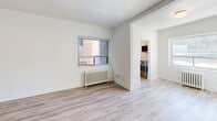 Located at 1650 Bathurst Street in Toronto's sought-after Forest Hill neighbourhood, this well-appointed 2-bedroom, 1-bathroom unit offers a thoughtfully laid-out single-floor plan with a clean, updated aesthetic. Light-toned laminate flooring runs consistently throughout, complementing the crisp white walls and white baseboards to create a bright, cohesive feel.

The spacious primary bedroom is generously sized, offering ample room for furnishings, and features a large window that draws in natural light along with a classic white cast-iron radiator. A closet and secondary door provide added convenience and connectivity to the rest of the unit. The second bedroom is similarly well-proportioned, also featuring a window with outdoor views and its own radiator, ensuring comfortable heating throughout the colder months.

The living area connects openly to the kitchen, which is equipped with stainless steel appliances and white cabinetry, offering a functional and modern cooking space. The bathroom is finished with white subway tile surrounding the bathtub, grey floor tiles, and a window for natural ventilation — presenting a clean, classic look. Classic radiator heating is present throughout the unit, reflecting the building's enduring character. The overall ambiance is fresh, neutral, and move-in ready.