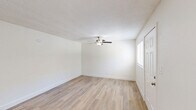 Located at 4830 Palm Avenue in Riverside, CA, this single-floor, one-bedroom, one-bathroom unit offers a clean and functional layout designed for efficient living. Throughout the space, light wood-style flooring and crisp white walls create a bright, neutral aesthetic that carries consistently from room to room.

The combined living and dining area serves as the heart of the unit, featuring a ceiling fan with integrated lighting, a textured ceiling, and a window fitted with blinds that allows natural light to fill the space. The entry door opens directly into this area, making for a straightforward, open flow.

The bedroom is a comfortable size, equipped with a ceiling fan, a wall-mounted window air conditioning unit, and a window overlooking the exterior. Two closets provide practical storage, with one featuring built-in shelving for added organization.

The bathroom is neatly appointed with a white vanity cabinet, a mirrored medicine cabinet, a wall-mounted light fixture, and a toilet, offering a clean and utilitarian design.

The kitchen completes the layout, rounding out a well-organized unit that prioritizes functionality. The consistent use of light tones and durable flooring throughout gives the space a cohesive, move-in-ready appearance.