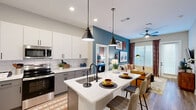 Located at 2307 N Tryon St in Charlotte, NC, this well-appointed three-bedroom, two-bathroom residence offers a thoughtfully designed single-floor layout with modern finishes throughout. Warm wood-look flooring flows seamlessly across the entire space, creating a cohesive and inviting atmosphere.

The kitchen is a standout feature, boasting white upper cabinetry, gray lower cabinetry, a subway tile backsplash, stainless steel appliances, and a central island with a white countertop — ideal for both cooking and casual dining. The adjoining living room provides a comfortable, open atmosphere with generous wall space and natural light filtering through large windows.

The primary bedroom is a well-sized retreat featuring a ceiling fan, ample natural light, and direct access to a dedicated closet and en-suite bathroom. The additional bedrooms are equally well-lit, each with large windows and stylish accent details. Both bathrooms are finished with gray vanity cabinetry, white countertops, and black hardware accents; one features a tub-shower combo with full tile surround, while the other includes a glass-enclosed shower.

A dedicated in-unit laundry room with side-by-side washer and dryer adds everyday convenience. Two closets provide ample storage throughout the home, completing this functional and modern Charlotte residence.