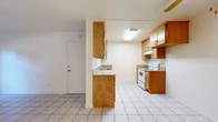 Located at 2227 E La Palma Ave in Anaheim, CA, this 2-bedroom, 3-bathroom single-floor residence offers a practical and well-organized layout. The entrance opens into a bright, neutral-toned interior finished with clean white walls and light tile flooring that flows through the main living areas. The living room is open and airy, featuring a ceiling fan and a sliding glass door dressed with vertical blinds that invites natural light and provides outdoor access. The galley-style kitchen is efficiently designed with warm oak cabinetry, granite-look countertops, a white electric range, a dishwasher, and a skylight that brightens the workspace. Both bedrooms feature hardwood-style plank flooring and receive ample natural light through windows with vertical blinds. The primary bedroom is generously sized and includes a sliding-door closet. The three bathrooms are finished with tile flooring, white vanity cabinetry, granite-tone countertops, and large mirrors with overhead lighting. A hallway connects the main areas of the home, and a dedicated closet provides additional storage. The space maintains a clean, functional aesthetic throughout, making it a comfortable and practical residence.