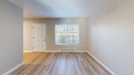 Located at 1118 Starbird Circle in San Jose, CA, this 2-bedroom, 1-bathroom residence offers a thoughtfully designed single-level layout with a clean, modern aesthetic throughout. Light wood-style flooring runs consistently across all rooms, lending warmth and visual continuity to the space.

The combined kitchen and living area serves as the heart of the home. The kitchen is outfitted with white shaker cabinetry, gray countertops, a subway tile backsplash, and stainless steel appliances including a range, dishwasher, and under-cabinet range hood. The adjoining living area receives natural light through a window overlooking greenery outside, with a baseboard heating system and a paneled entry door.

Both bedrooms feature ceiling fans with integrated lighting, light-filled windows with blinds, and baseboard heaters. The primary bedroom includes a sliding mirrored closet and direct access to a private outdoor deck through glass sliding doors—an excellent source of natural light and outdoor connectivity. The second bedroom also benefits from a garden-facing window.

The bathroom is finished with wood-look flooring, white cabinetry with brushed nickel hardware, a gray countertop vanity, and a full tub-shower combination with white tile surround. A hallway connects the main living areas, completing this well-appointed and efficiently organized home.