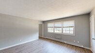 Located at 1739 Foxon Rd in North Branford, CT, this one-bedroom, one-bathroom unit offers a practical and well-organized single-floor layout. Light-toned vinyl plank flooring runs consistently throughout the space, creating a cohesive and easy-to-maintain interior. Neutral gray walls complement the clean white trim and baseboards found in every room.

The spacious living room is a highlight of the unit, featuring multiple windows fitted with horizontal blinds that invite abundant natural light. Baseboard heating units line the walls, providing efficient warmth. The open-concept kitchen is equipped with warm oak cabinetry, dark granite countertops, and a full suite of stainless steel appliances including a refrigerator, dishwasher, and range.

The generously sized bedroom includes multiple closets — offering notable storage capacity — along with its own windows and the same consistent flooring found elsewhere. A connecting hallway provides access to additional closet space throughout the unit.

The bathroom features white tile wainscoting, a tub-shower combination, a toilet, and a vanity with matching granite countertops, maintaining a cohesive design language. The overall layout is efficient and functional, making practical use of every square foot available in this North Branford residence.