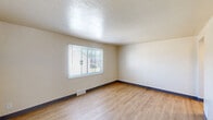Located at 165 Princeton Avenue in Buffalo, NY, this three-bedroom, one-bathroom unit offers a practical and well-organized single-floor layout. Light wood laminate flooring runs consistently throughout, complemented by neutral cream-toned walls and dark contrasting baseboards, creating a clean and cohesive aesthetic.

The primary bedroom is the most spacious of the three, featuring two windows that allow ample natural light and views of the surrounding neighborhood. The additional bedrooms are similarly finished with the same wood flooring and neutral walls; one includes a window with neighborhood views, while another features a closet for added storage.

The kitchen is well-equipped with warm honey-toned wood cabinetry, granite-style countertops, a stainless steel sink, and a gas range, along with a window that brings in natural light. The full bathroom includes a shower-tub combination with built-in shelving, a toilet, and a frosted window for privacy and ventilation.

A hallway connects the rooms efficiently, and the entry area features a solid exterior door alongside a window overlooking the neighborhood. Floor-plan views confirm a compact yet functional arrangement that maximizes the use of available space throughout the unit.