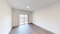 This well-appointed 2-bedroom, 2-bathroom unit at 945 W Clark Rd in Ypsilanti, Michigan offers a thoughtfully designed single-floor layout with modern finishes throughout. The open-concept living area is anchored by light wood-look flooring, crisp white walls, and a sliding glass door that leads to a private balcony with outdoor views—filling the space with natural light. A programmable thermostat adds a layer of everyday convenience.

The kitchen is a standout feature, showcasing grey shaker-style cabinetry, granite-look countertops, stainless steel appliances including a gas range, microwave, dishwasher, and refrigerator, complemented by a deep double-basin sink. The layout flows seamlessly into the living area, making it ideal for both cooking and entertaining.

The primary bedroom is a comfortable retreat with dedicated closet space, while the second bedroom features soft carpeting and a window offering exterior views. Both rooms include closet storage. The two bathrooms are cleanly finished with wood-look flooring, granite-top vanities with grey cabinetry, and full tub/shower combinations with built-in shelving. The overall ambiance is clean, contemporary, and move-in ready.