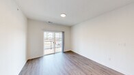 This well-appointed 2-bedroom, 2-bathroom unit at 945 W Clark Rd in Ypsilanti, Michigan offers a thoughtfully designed single-floor layout with modern finishes throughout. The open-concept living area is anchored by light wood-look flooring, crisp white walls, and a sliding glass door that leads to a private balcony with outdoor views—filling the space with natural light. A programmable thermostat adds a layer of everyday convenience.

The kitchen is a standout feature, showcasing grey shaker-style cabinetry, granite-look countertops, stainless steel appliances including a gas range, microwave, dishwasher, and refrigerator, complemented by a deep double-basin sink. The layout flows seamlessly into the living area, making it ideal for both cooking and entertaining.

The primary bedroom is a comfortable retreat with dedicated closet space, while the second bedroom features soft carpeting and a window offering exterior views. Both rooms include closet storage. The two bathrooms are cleanly finished with wood-look flooring, granite-top vanities with grey cabinetry, and full tub/shower combinations with built-in shelving. The overall ambiance is clean, contemporary, and move-in ready.