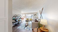 Located at 550 Los Arbolitos Boulevard in Oceanside, CA, this single-floor, 2-bedroom, 2-bathroom home offers a thoughtfully designed coastal-inspired interior. The open living and dining area features wood-style flooring, a textured ceiling, and large windows that invite abundant natural light and neighborhood views. The galley-style kitchen is outfitted with white shaker cabinetry, subway tile backsplash, a stainless steel sink, and black appliances including a gas range and dishwasher. The spacious primary bedroom features plush carpeting, a window with natural light, and ample closet space. The second bedroom, also carpeted, offers comfortable room for multiple beds. Two full bathrooms serve the home — one features a white vanity with quartz countertop, a tub-shower combination, and wood-style flooring, while the second includes a wide vanity with generous cabinetry and a built-in linen tower. A dedicated entrance, hallway, and three closets contribute to practical storage throughout. The space maintains a bright, neutral palette with coastal accents, creating a welcoming and relaxed ambiance well-suited to the Southern California lifestyle.