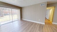 This contemporary apartment in Temple Terrace, FL offers 820 square feet of well-designed living space. The open floor plan maximizes the area, creating a seamless flow between rooms. The kitchen is a highlight, featuring white cabinetry, granite countertops, and a stylish mosaic tile backsplash. Stainless steel appliances complement the modern aesthetic.

Both bathrooms boast granite vanity tops and large mirrors, enhancing the sense of space. The primary bedroom, measuring 180 square feet, provides ample room for relaxation. Light-toned wood-look flooring runs throughout the apartment, unifying the space and reflecting natural light from the large windows.

The living area is bright and airy, with a sliding glass door leading to an outdoor space. In-unit laundry adds convenience to daily life. Neutral wall colors create a canvas for personal style, while textured ceilings add visual interest.

This apartment combines functionality with contemporary design, offering a comfortable and stylish living environment in a prime Florida location.