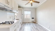 Located at 5014 Melrose Ave in the heart of Los Angeles, this one-bedroom, one-bathroom unit offers a thoughtfully designed and efficient living space. The unit features light wood-style luxury vinyl flooring throughout, creating a bright and cohesive look that ties the entire space together.

The main living area is open and versatile, with neutral-toned walls, crisp white crown molding, and a ceiling fan overhead. Natural light filters in through windows, enhanced by a wall-mounted heating unit that ensures year-round comfort. The kitchen is neatly appointed with white shaker-style cabinetry, a marble-look countertop, a stainless steel sink, and a full-size refrigerator — all framed by a window with views of the surrounding neighborhood.

The bathroom features a clean, classic design with floor-to-ceiling white square tile in the walk-in shower, complemented by traditional hexagon mosaic tile flooring and chrome fixtures. A dedicated closet provides convenient storage within the compact footprint.

The overall aesthetic is clean, minimal, and move-in ready, with a bright and airy ambiance that maximizes the use of every square foot. Ideally situated along the vibrant Melrose corridor, this unit offers easy access to dining, shopping, and entertainment throughout Los Angeles.