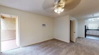 Located at 854 Vine St in Oceanside, California, this single-story home offers a well-organized layout with a variety of functional spaces throughout. The living area is generously sized, featuring plush carpeted flooring, a ceiling fan with light fixture, and a textured ceiling. Natural light filters in through horizontal blinds, and a wall-mounted AC unit provides climate control. An open sightline connects the living area to the kitchen, which is equipped with a U-shaped layout, white cabinetry, dark granite-style countertops, a double-basin sink, a black electric range, and wood-look tile flooring — all complemented by a window above the sink. The bedrooms are carpeted and well-lit, with windows offering views of surrounding greenery. One bedroom features a built-in closet with shelving for ample storage, while another includes ceiling fan lighting and direct access to an outdoor area. The bathrooms are finished with wood-look tile flooring, white vanity cabinetry, dark countertops, large mirrors, and overhead vanity lighting. The overall interior presents a clean, neutral palette with functional finishes, making this Oceanside property a practical and comfortable single-level home.